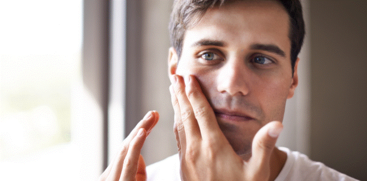 Man touching his face, analysing his face shape
