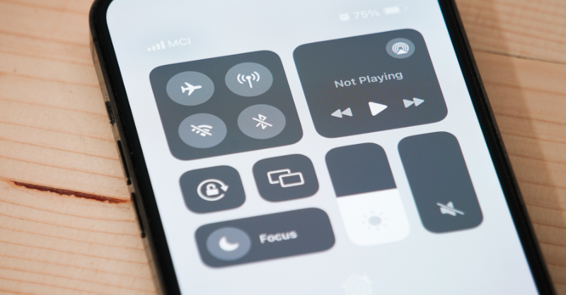 An iPhone screen settings showing the screen brightness decreased.