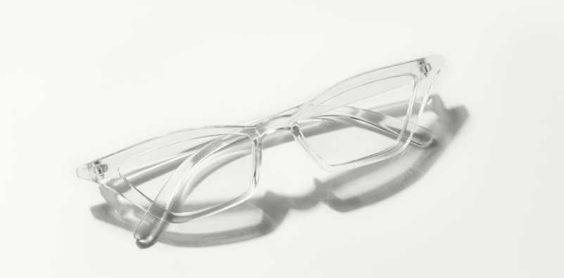 A pair of clear eyeglasses on white background.