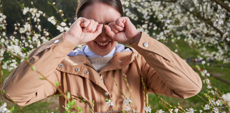 A young woman suffering from a seasonal allergy in springtime.